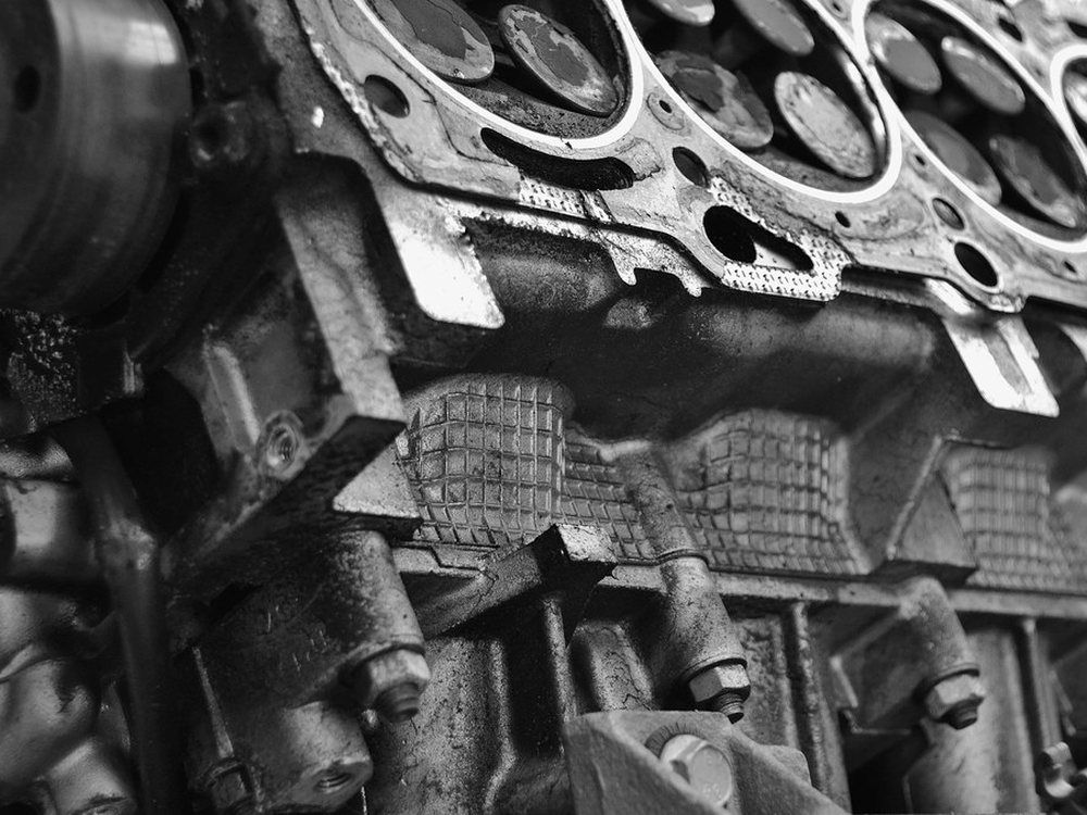 A black and white close view of the inside of a car engine